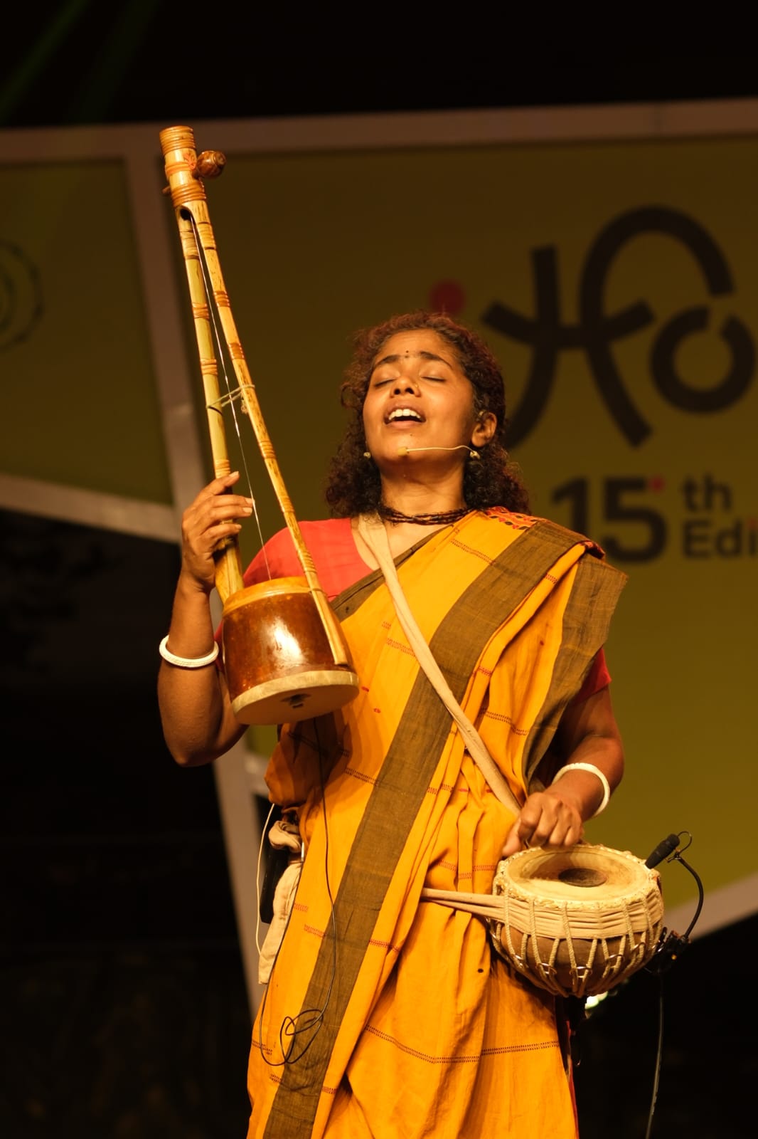 Santhi Priya performing with ektara and drum